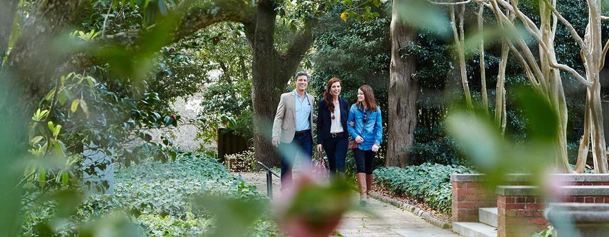 A family takes a walk through Hopeland Gardens. 