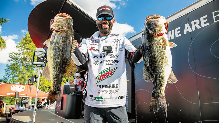 guy holding up two fish