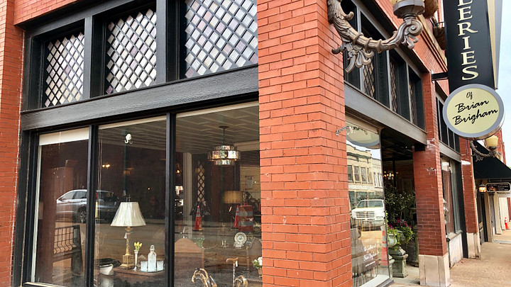 Corner antique shop with lamp and furnishings in window