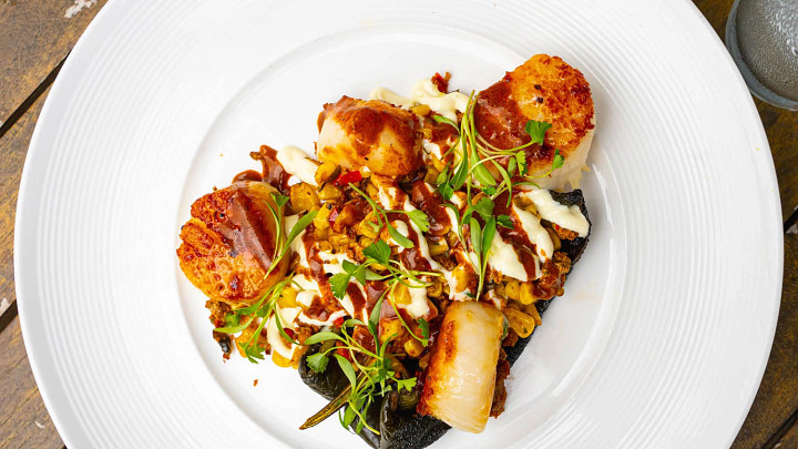 Poblano crema, lime aioli and chorizo vinaigrette give sweet scallops and roasted corn Mexican street food vibes.