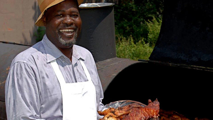 Bill Green, owner of Gullah Grub, holding ribs