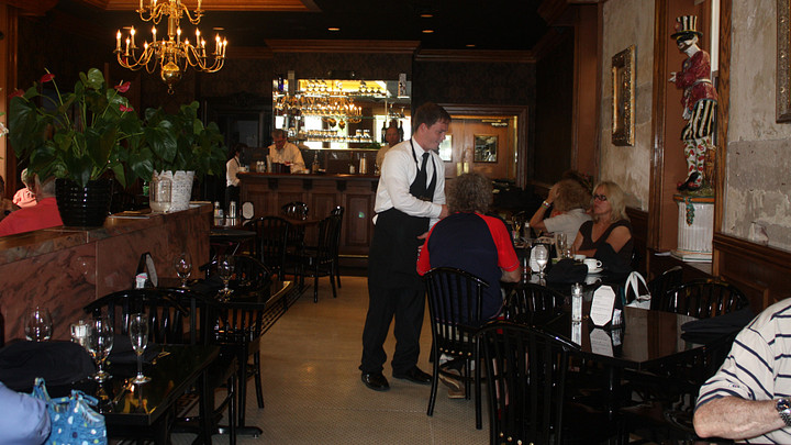 Server waiting on table of customers at restaurant