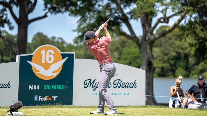Golfer mid swing at Myrtle Beach Classic