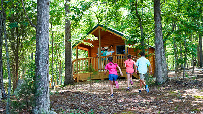 kids running to a cabin at Dreher Island State Park